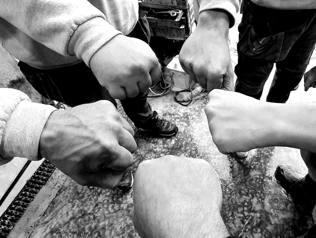 The Amaris team fist bump in the Bridgend workshop — hiring stone craftspeople