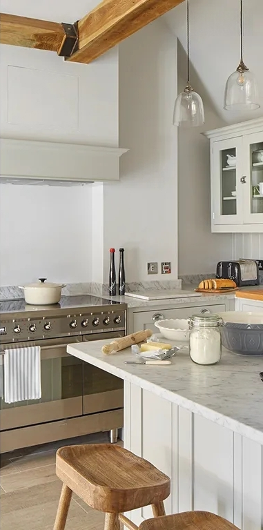 After — Carrara marble · beamed cottage kitchen