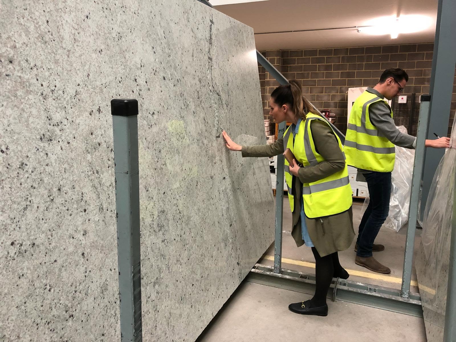 Amaris team inspecting a granite slab in the stone yard, Bridgend